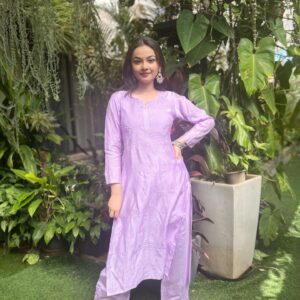 Woman posing in a light purple lavender Chanderi dyeable Chikankari style embroidered kurti with matching palazzo pants set