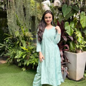 Woman wearing a mint sea green Chanderi dyeable Chikankari style embroidered kurti with matching palazzo pants set